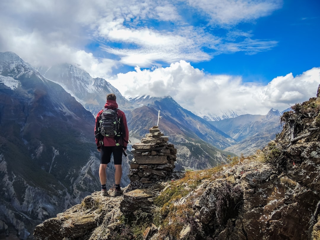 person hiking on mountain trail back pain posture